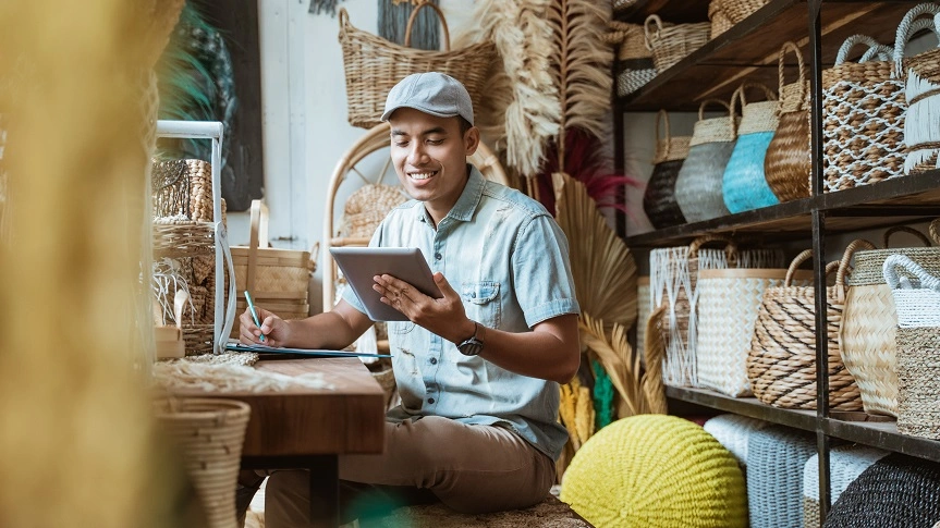  Homem sentado em mesa com caneta e tablet em mãos 