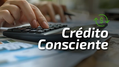 Mãos no teclado com a escrita de "crédito consciente" na tela em destaque.