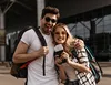  casal em aeroporto com passaporte na mão antes de viajar 